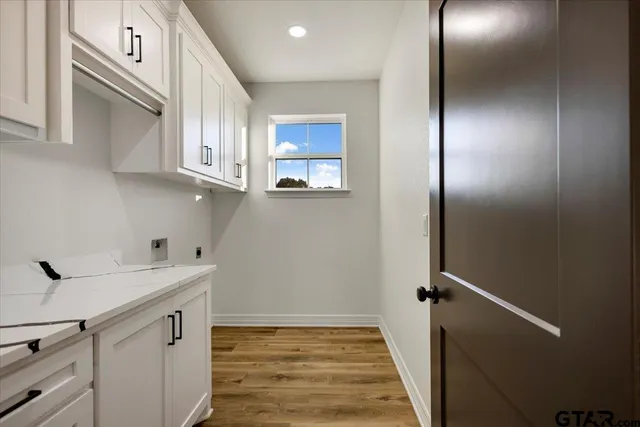 a kitchen with white cabinets and a sink