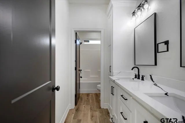 a bathroom with a double vanity sink mirror and double