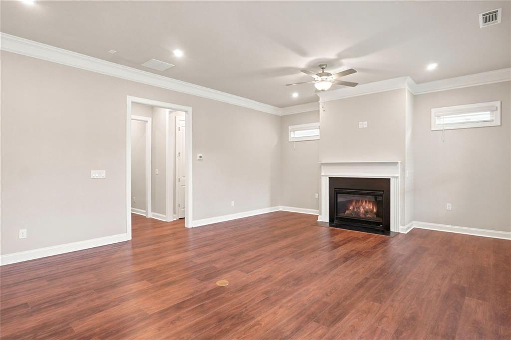 2070 Abbey Road Roswell, GA 30076 - Photo 17 of 65 a view of an empty room with wooden floor fireplace and a window
