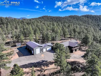 a view of a terrace with a table and chairs under an umbrella