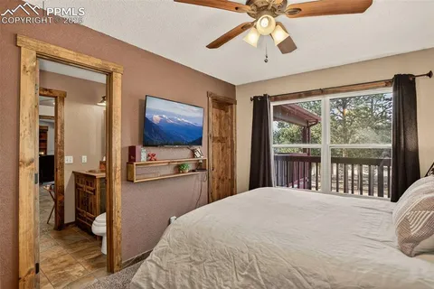a bedroom with a large bed and a large window