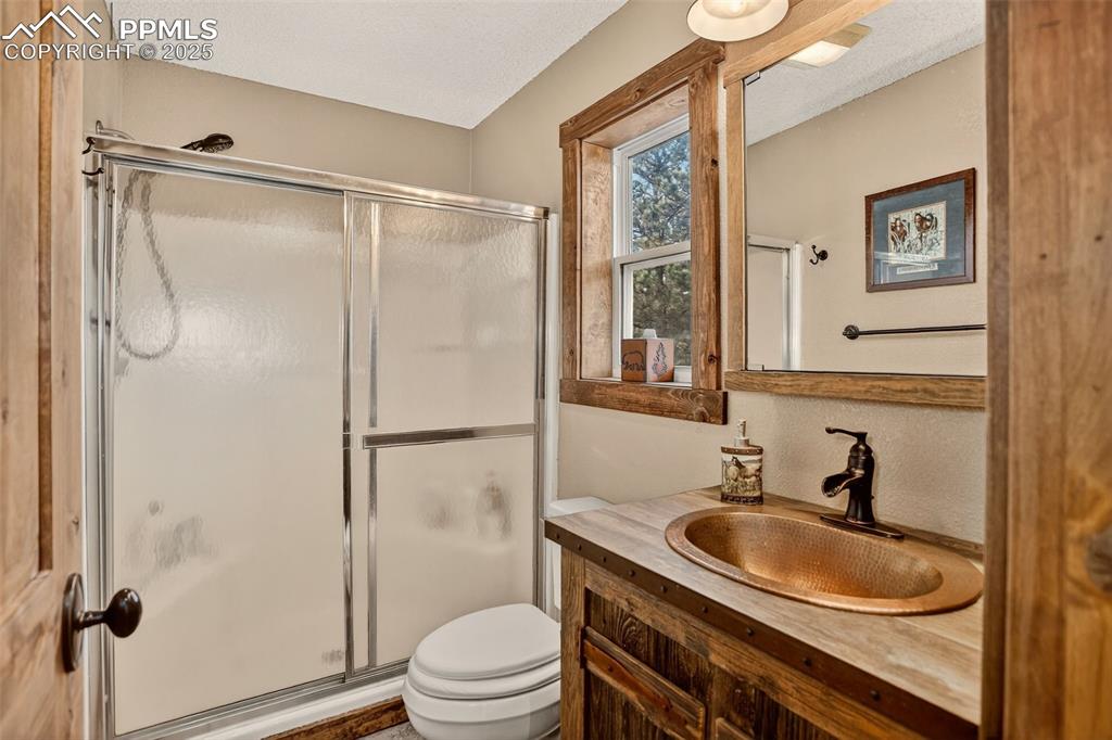 50 Rd P78 Bailey, CO 80421 - Photo 21 of 49 a bathroom with a granite countertop sink toilet and shower