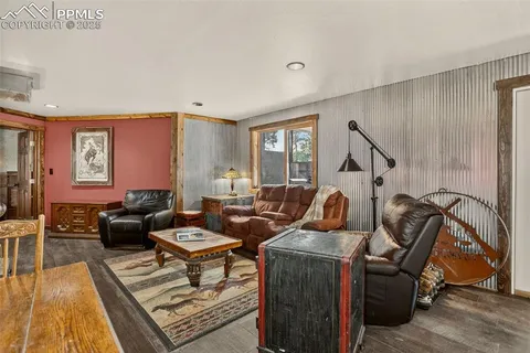a kitchen with a stove a refrigerator and a wooden floor