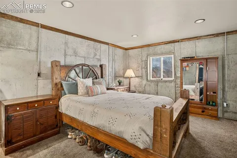 a bed sitting in a room next to a lamp