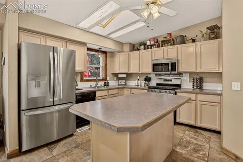 a view of kitchen island with furniture and chandelier