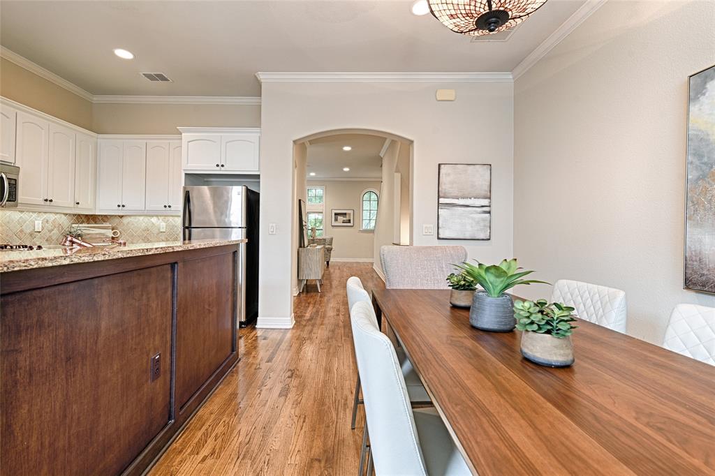 6269 Oram Street, Unit 10 Dallas, TX 75214 - Photo 11 of 25 a kitchen with kitchen island white cabinets and stainless steel appliances