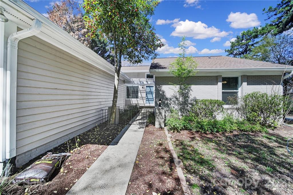 7032 Cambridge Circle Tega Cay, SC 29708 - Photo 2 of 36 a front view of a house with garden