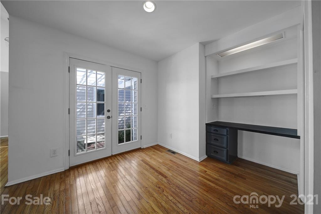 7032 Cambridge Circle Tega Cay, SC 29708 - Photo 17 of 36 a view of an empty room with wooden floor and a window