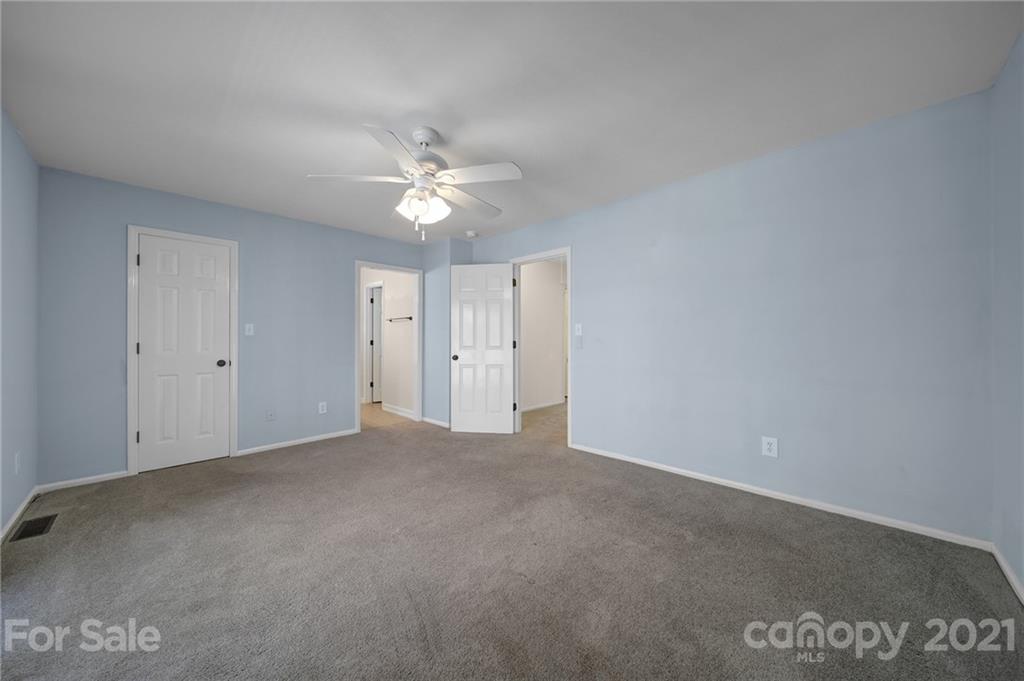 7032 Cambridge Circle Tega Cay, SC 29708 - Photo 19 of 36 a view of an empty room with a ceiling fan