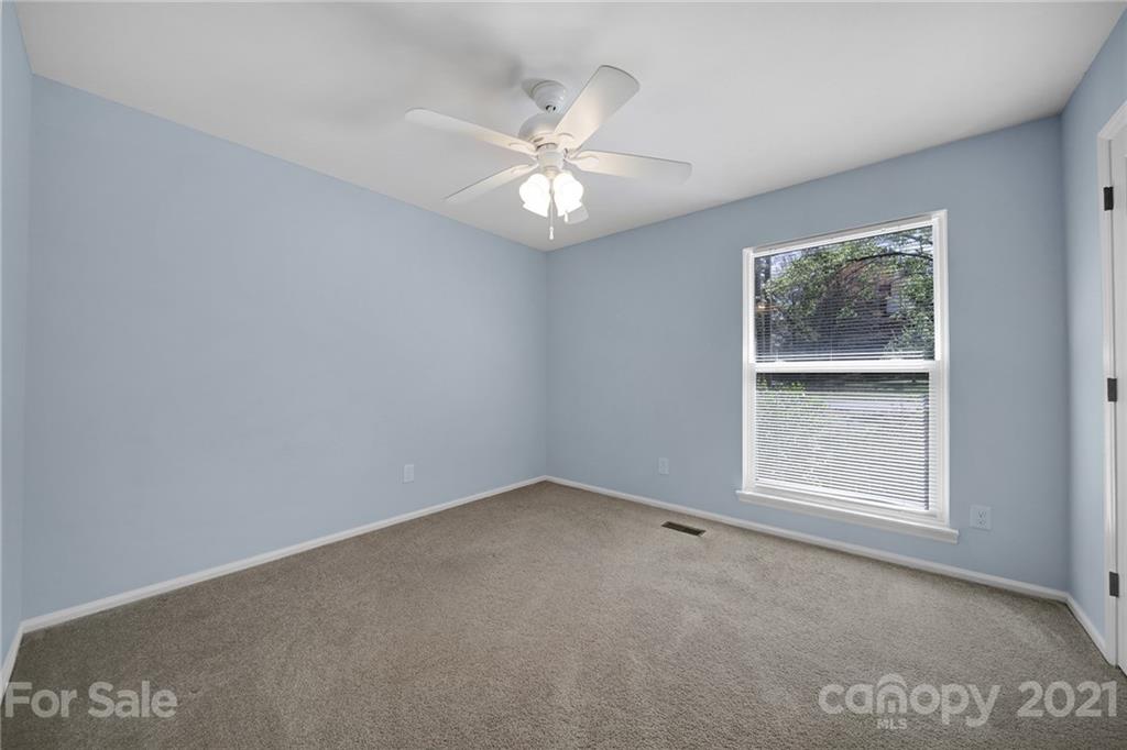 7032 Cambridge Circle Tega Cay, SC 29708 - Photo 23 of 36 an empty room with a window and a fan