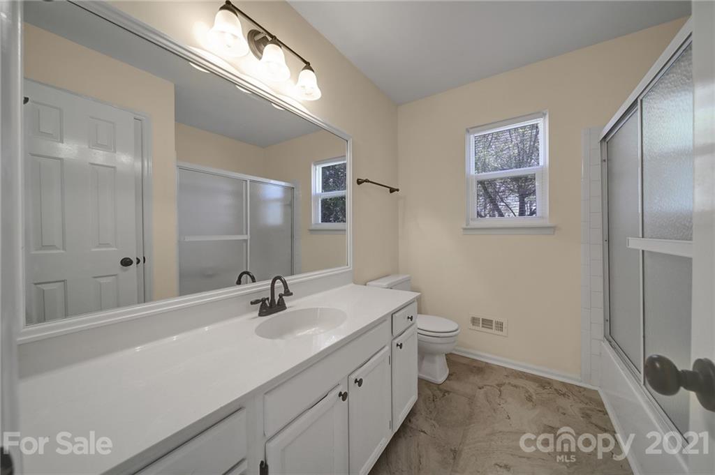 7032 Cambridge Circle Tega Cay, SC 29708 - Photo 27 of 36 a bathroom with a sink a toilet and shower