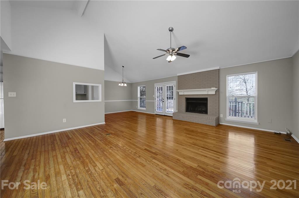 7032 Cambridge Circle Tega Cay, SC 29708 - Photo 6 of 36 a view of an empty room with a fireplace and a window
