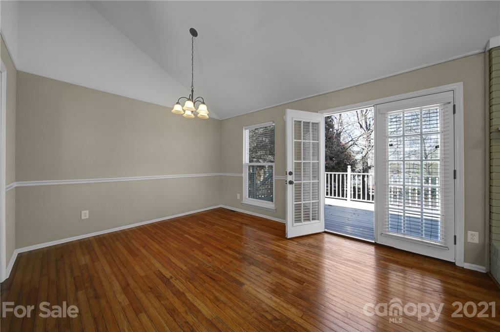 7032 Cambridge Circle Tega Cay, SC 29708 - Photo 9 of 36 a view of a room with wooden floor and large window