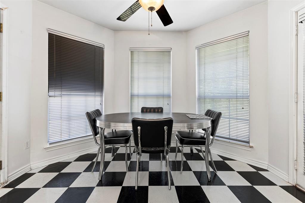 401 Rugged Drive Red Oak, TX 75154 - Photo 16 of 40 Breakfast nook featuring a bay window, black and white checkered flooring, and a ceiling fan
