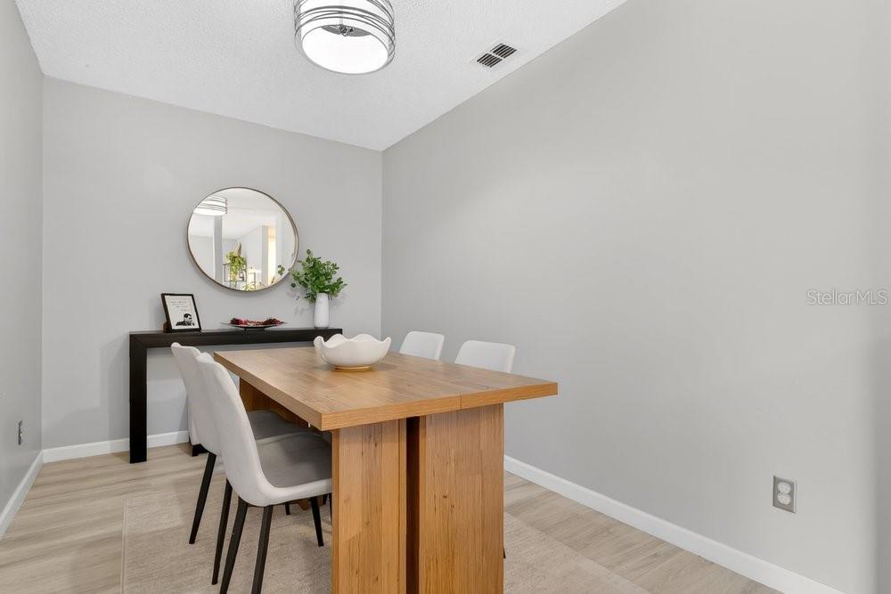 4227 Pershing Pointe Place, Unit 2 Orlando, FL 32822 - Photo 11 of 34 a view of a table and chairs in a room