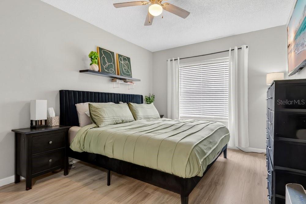 4227 Pershing Pointe Place, Unit 2 Orlando, FL 32822 - Photo 12 of 34 a bedroom with a bed and a chandelier