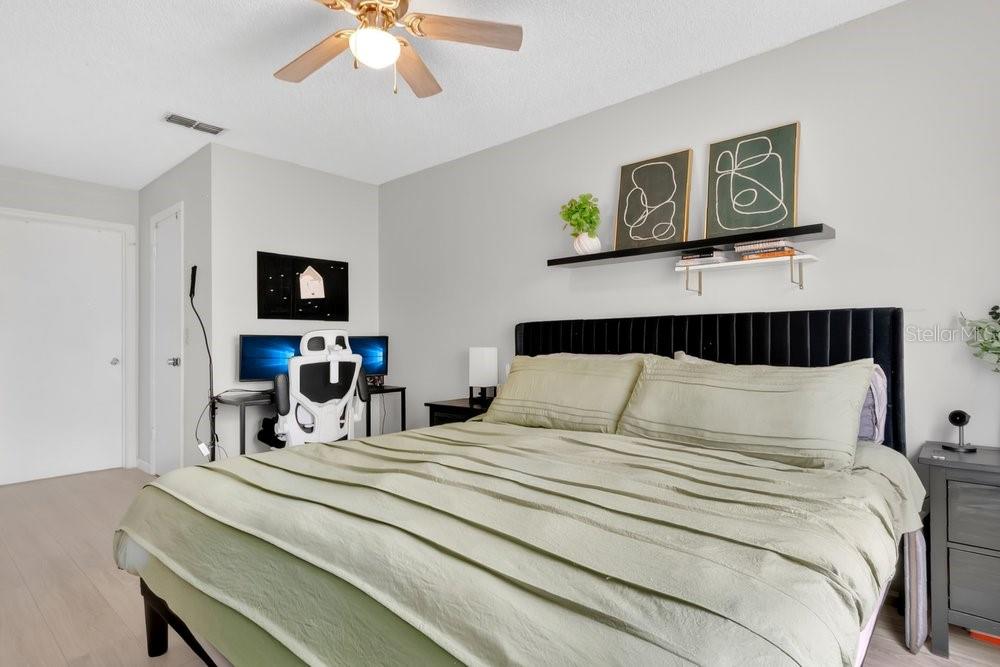 4227 Pershing Pointe Place, Unit 2 Orlando, FL 32822 - Photo 13 of 34 a bedroom with a bed and a tv
