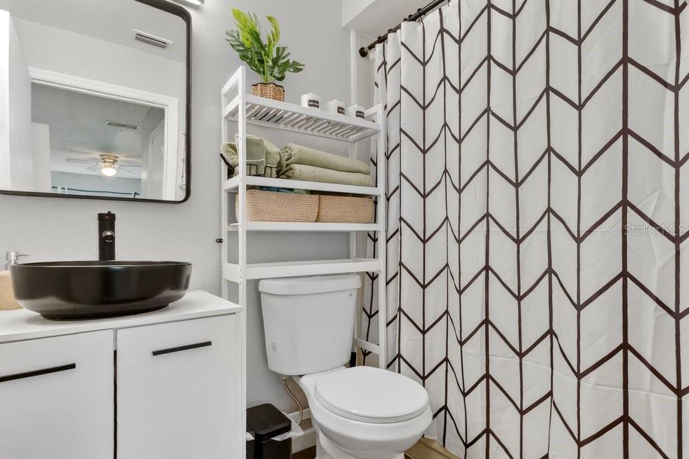 4227 Pershing Pointe Place, Unit 2 Orlando, FL 32822 - Photo 14 of 34 a bathroom with a toilet sink and mirror