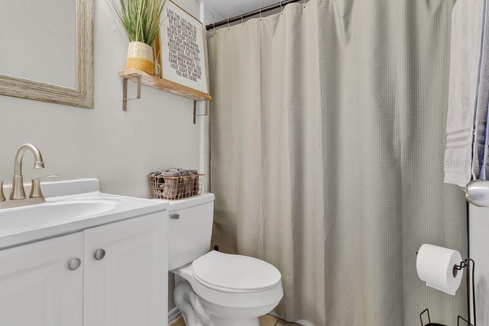 4227 Pershing Pointe Place, Unit 2 Orlando, FL 32822 - Photo 15 of 34 a bathroom with a toilet a sink and a mirror