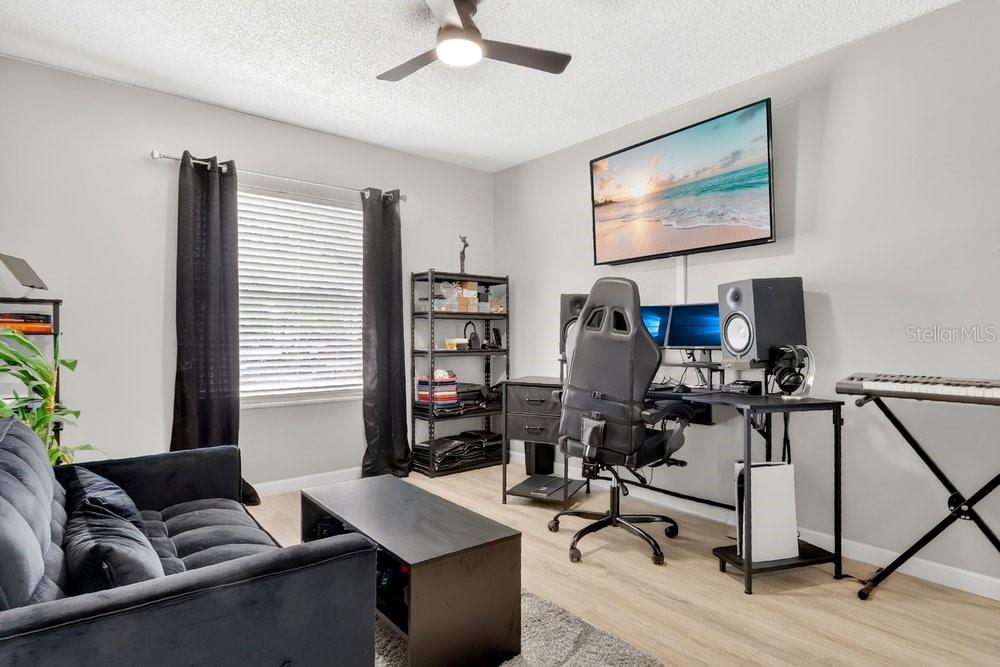 4227 Pershing Pointe Place, Unit 2 Orlando, FL 32822 - Photo 16 of 34 a living room with furniture and a flat screen tv