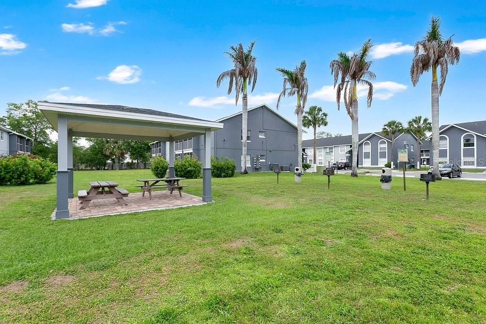 4227 Pershing Pointe Place, Unit 2 Orlando, FL 32822 - Photo 21 of 34 a view of a house with a big yard and palm trees