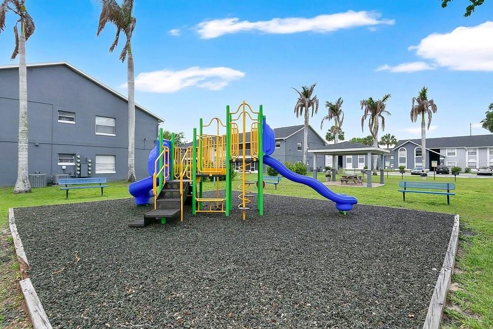 4227 Pershing Pointe Place, Unit 2 Orlando, FL 32822 - Photo 23 of 34 a view of outdoor space with playground and green space