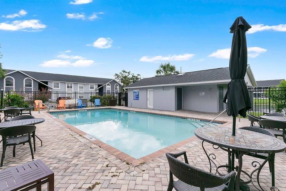 4227 Pershing Pointe Place, Unit 2 Orlando, FL 32822 - Photo 25 of 34 a swimming pool with outdoor seating