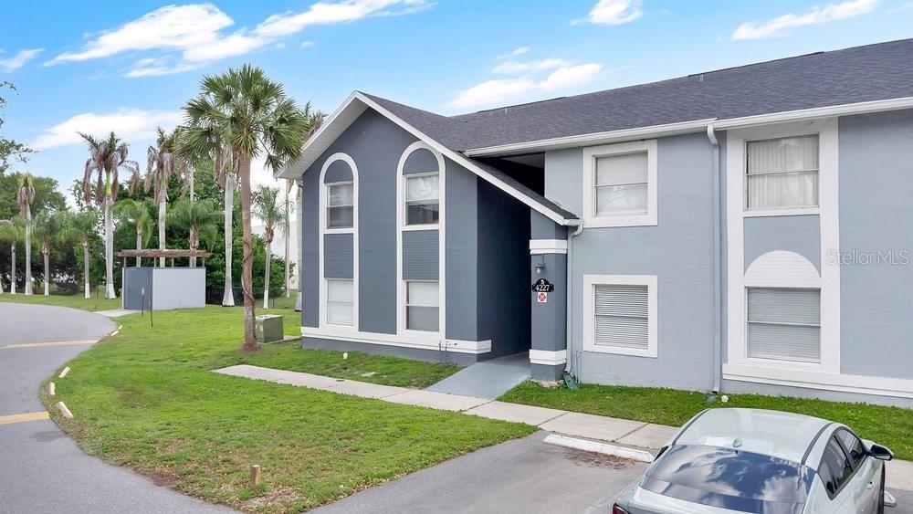 4227 Pershing Pointe Place, Unit 2 Orlando, FL 32822 - Photo 3 of 34 a front view of a house with a yard