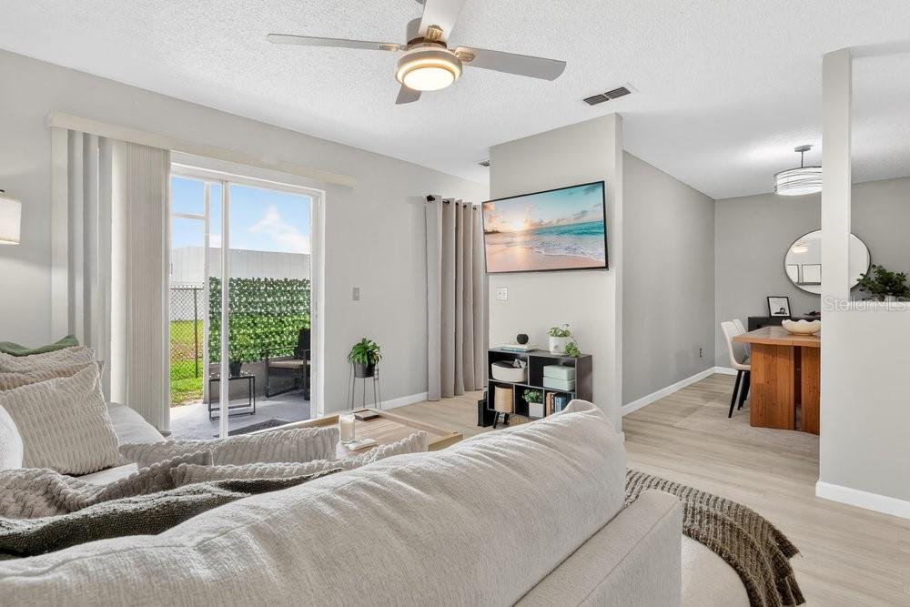 4227 Pershing Pointe Place, Unit 2 Orlando, FL 32822 - Photo 5 of 34 a bedroom with a bed and a chandelier