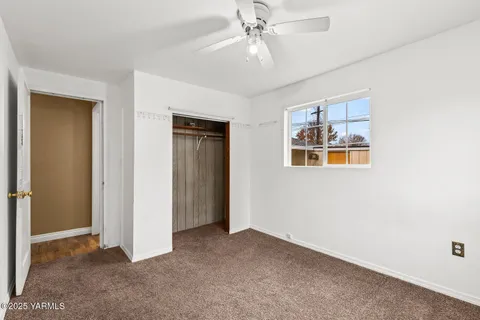 a view of an empty room with a fan