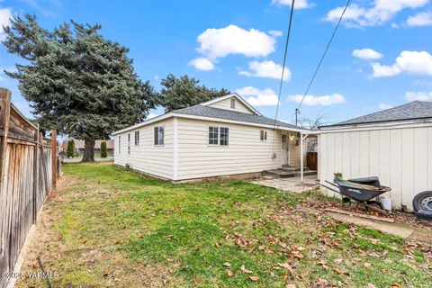 a view of a backyard with plants and a patio