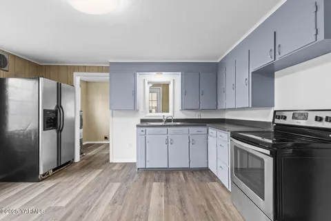 a kitchen with a sink stove and refrigerator