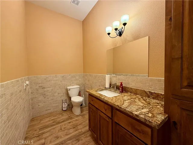 a bathroom with a toilet and a mirror