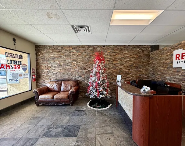 a view of a dining room with furniture and a window