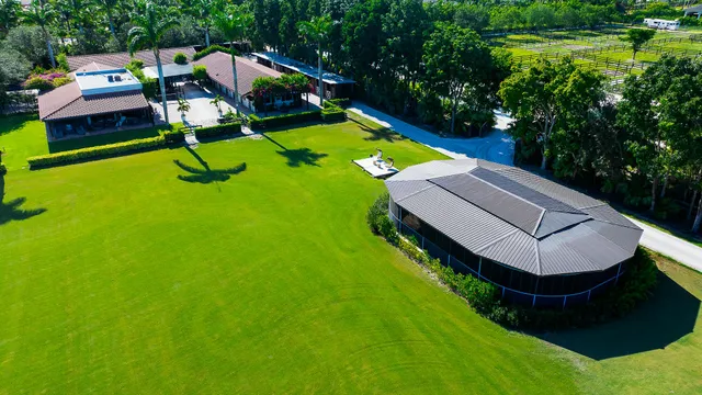 an aerial view of a house with a yard