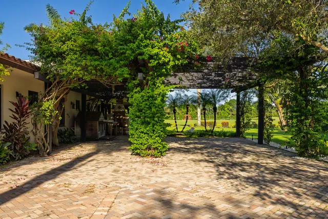 a backyard of a house with table and chairs