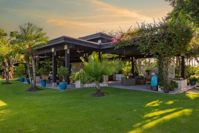 a side view of a house with a tree