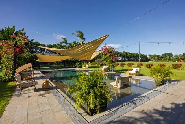 a view of a patio with a table chairs and a backyard