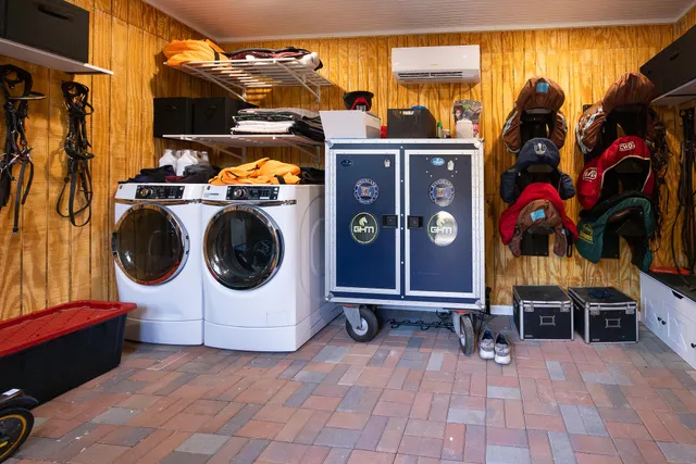 a kitchen with a table chairs a microwave and cabinets