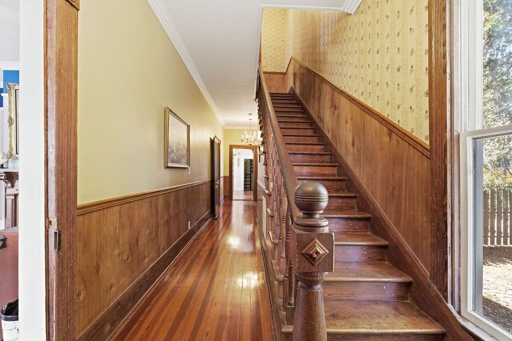 720 Southeast 3rd Street Ocala, FL 34471 - Photo 14 of 82 a view of a hallway with wooden floor and staircase