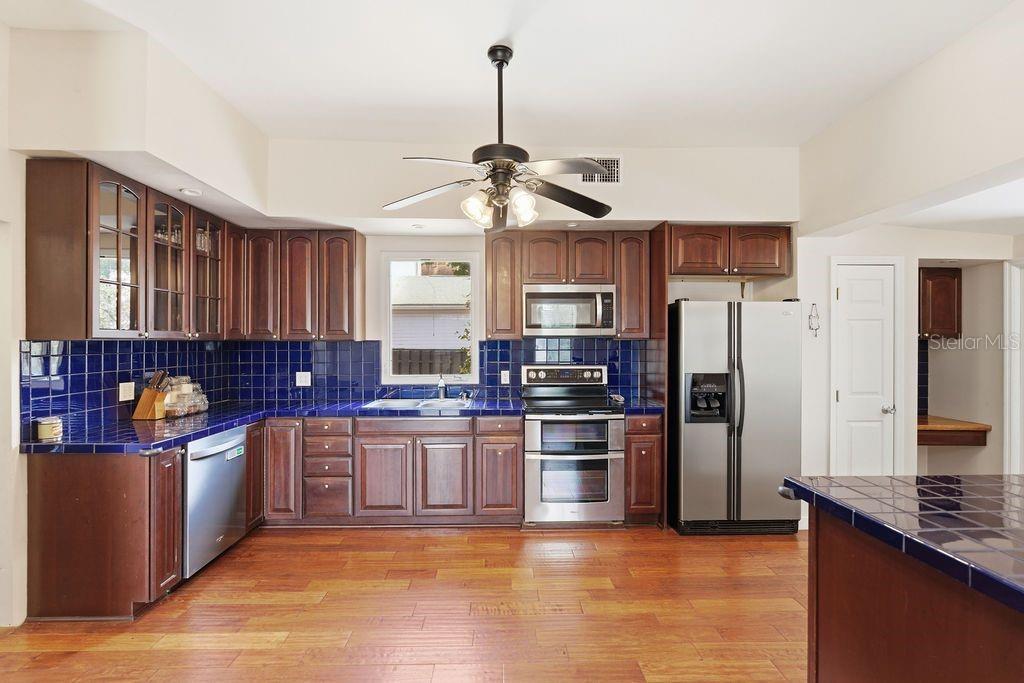 720 Southeast 3rd Street Ocala, FL 34471 - Photo 24 of 82 a kitchen with stainless steel appliances granite countertop a stove refrigerator and cabinets