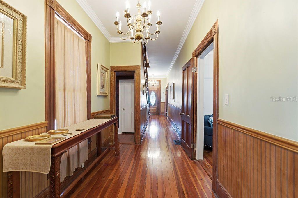720 Southeast 3rd Street Ocala, FL 34471 - Photo 34 of 82 a view of a hallway with wooden floor and staircase