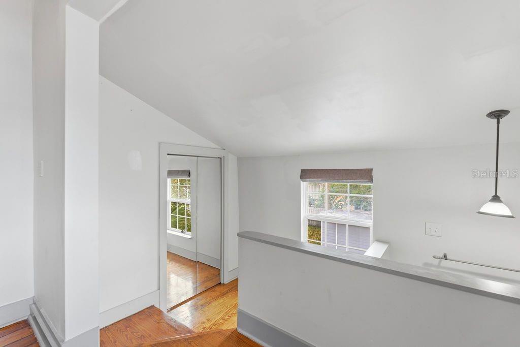 720 Southeast 3rd Street Ocala, FL 34471 - Photo 45 of 82 a view of an empty room with wooden floor and a window