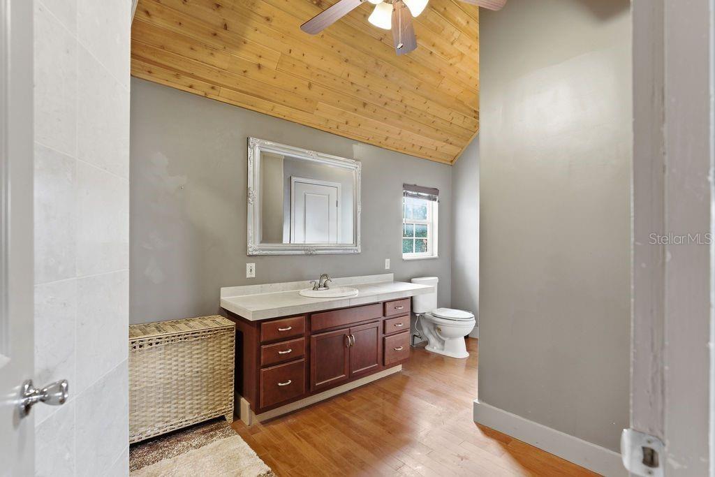 720 Southeast 3rd Street Ocala, FL 34471 - Photo 49 of 82 a bathroom with a granite countertop toilet a sink and mirror