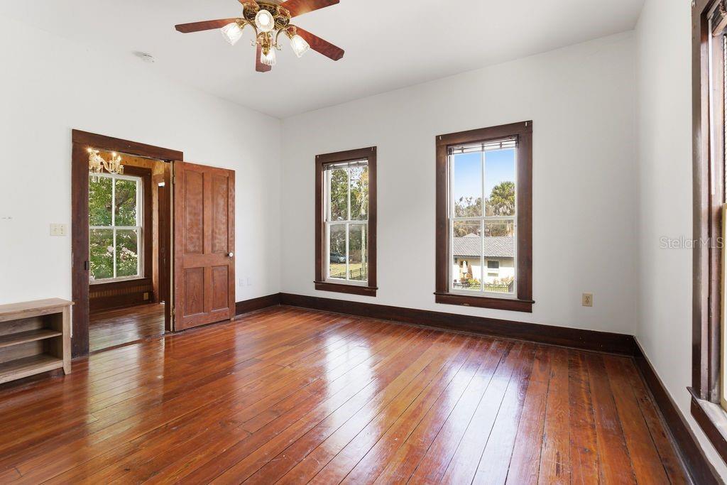 720 Southeast 3rd Street Ocala, FL 34471 - Photo 54 of 82 a view of an empty room with wooden floor and a window
