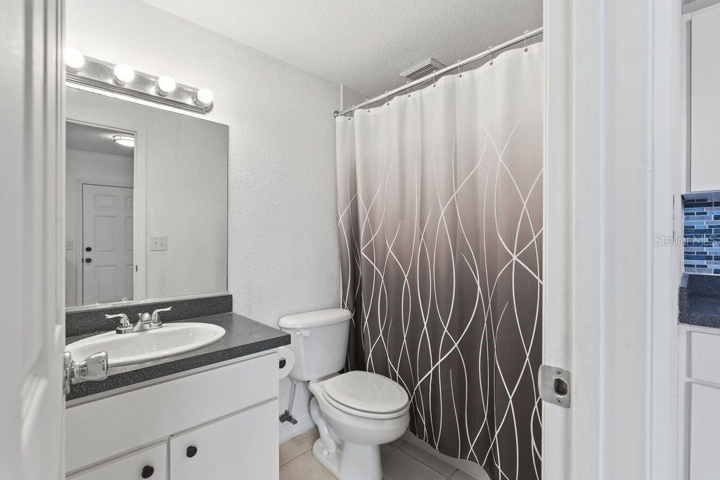 720 Southeast 3rd Street Ocala, FL 34471 - Photo 59 of 82 a bathroom with a granite countertop sink toilet and a mirror
