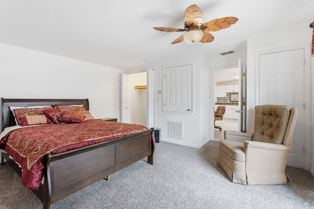 720 Southeast 3rd Street Ocala, FL 34471 - Photo 62 of 82 a bed room with a bed and a chandelier