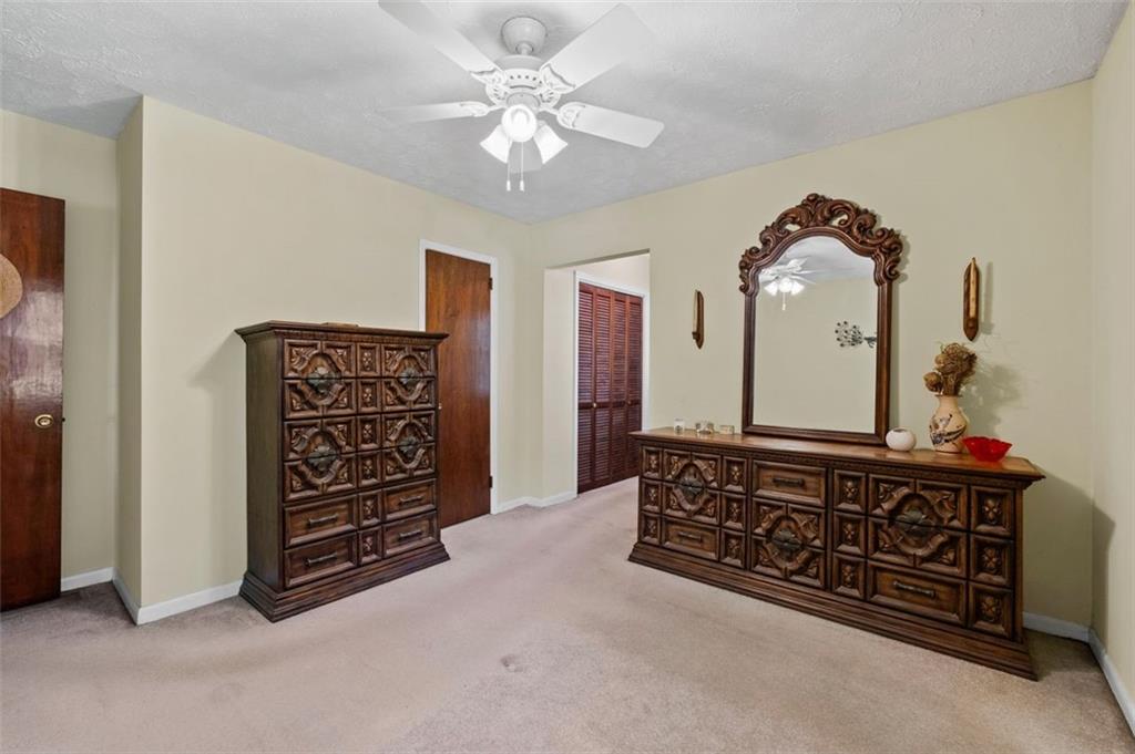 2880 Sherwood Road Southeast Smyrna, GA 30082 - Photo 21 of 33 a spacious bedroom with a bed and a chandelier