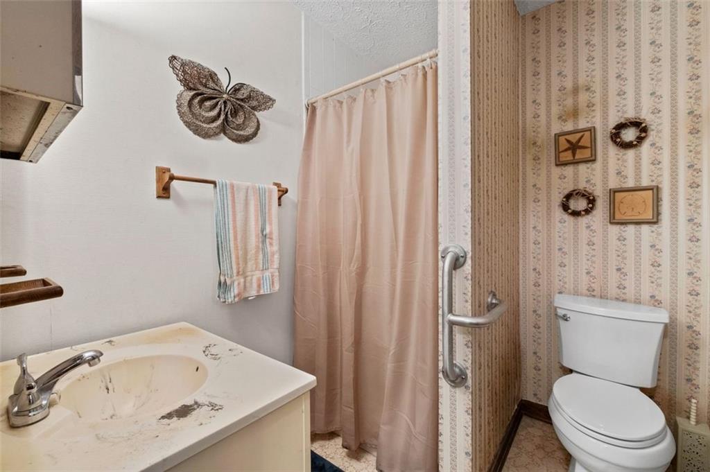 2880 Sherwood Road Southeast Smyrna, GA 30082 - Photo 23 of 33 a bathroom with a sink and a shower curtain