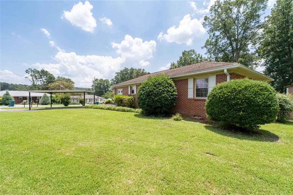 2880 Sherwood Road Southeast Smyrna, GA 30082 - Photo 5 of 33 a view of a house with a big yard and potted plants